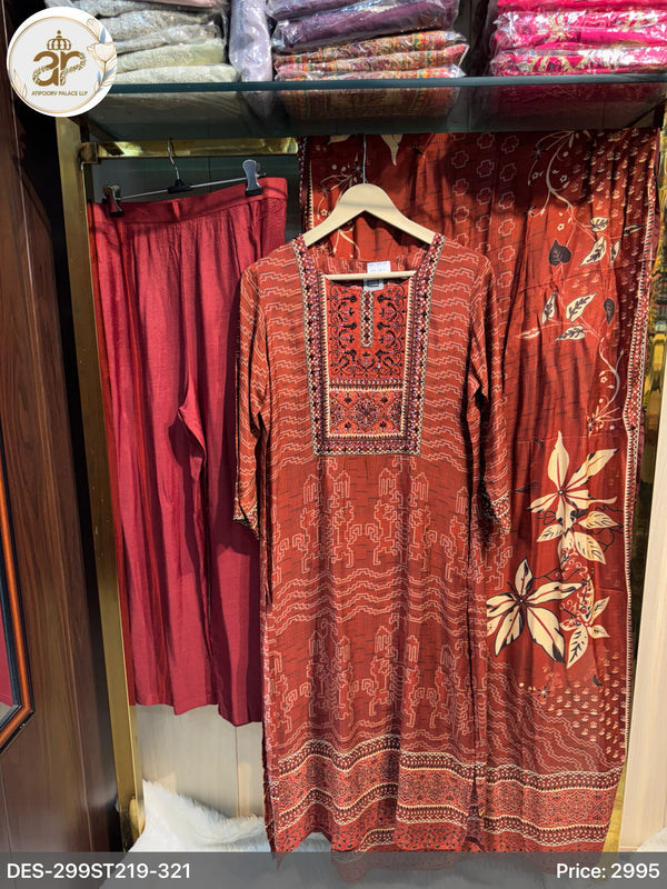 Red embroidered dress on a hanger with red pants in the background