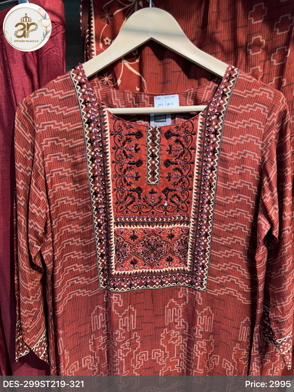 Red embroidered traditional garment on a hanger with a blurred background